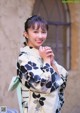 A woman in a kimono posing for a picture.