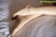 A close up of a woman's legs on a bed.