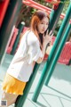 A young woman leaning against a playground equipment.