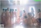 A group of naked women sitting on the floor in a room.