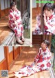 A woman in a kimono sitting on a wooden porch.