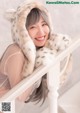 A woman in a fur coat posing for a picture.