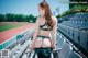 A woman in a bikini standing in a stadium.