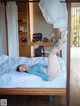 A woman laying on top of a bed in a bedroom.