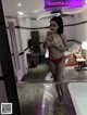 A woman in a red bikini taking a selfie in a mirror.