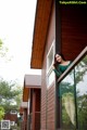 A woman in a green dress standing on a balcony.